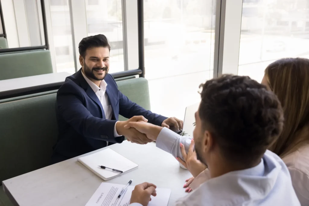 People in business meeting shaking hands
